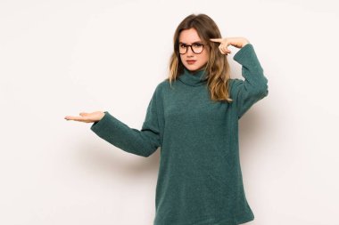 Beyaz duvar parmak kafasına koyarak delilik jest yapma genç kız