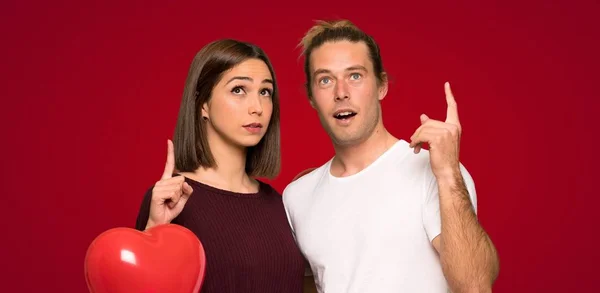 Couple Valentine Day Thinking Idea Pointing Finger Red Background — Stock Photo, Image