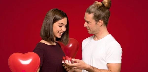 Couple Valentine Day Holding Gift Box Red Background — Stock Photo, Image