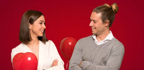 Couple Valentine Day Keeping Arms Crossed While Smiling Red Background — Stock Photo, Image