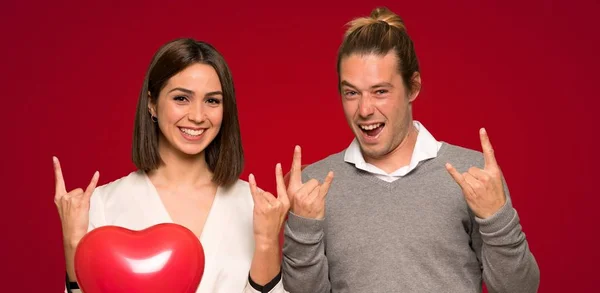 Couple Valentine Day Making Rock Gesture Red Background — Stock Photo, Image