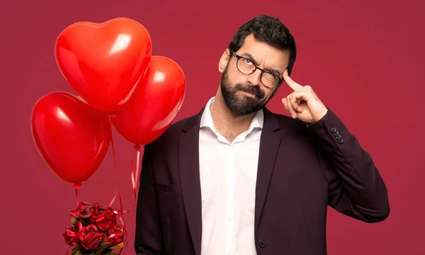 Hombre Día San Valentín Teniendo Dudas Pensando Sobre Fondo Rojo —  Fotos de Stock