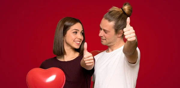 Couple Valentine Day Giving Thumbs Gesture Red Background — Stock Photo, Image