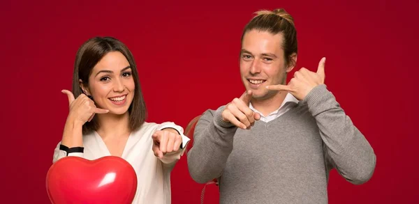 Couple Valentine Day Making Phone Gesture Pointing Front Red Background — Stock Photo, Image