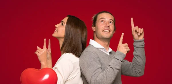 Couple Valentine Day Pointing Index Finger Great Idea Red Background — Stock Photo, Image