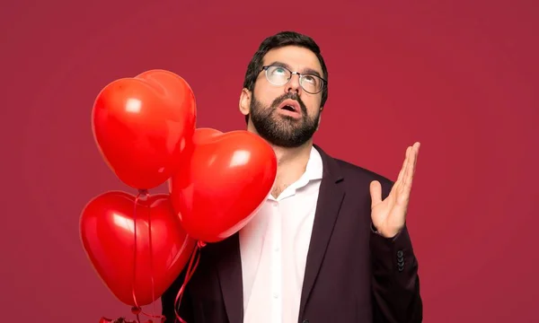 Man in valentine day frustrated by a bad situation over red background