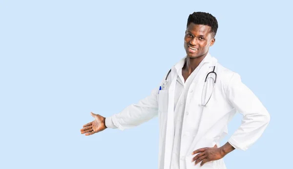 Afro Amerikai Orvos Mutatva Vissza Mutatóujjával Bemutató Termék Elszigetelt Kék — Stock Fotó