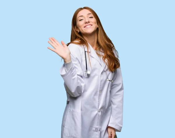 Ruiva Médico Mulher Saudando Com Mão Com Expressão Feliz Fundo — Fotografia de Stock