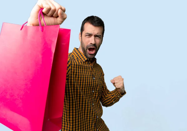 Mannen Med Shoppingkassar Fira Seger Isolerade Blå Bakgrund — Stockfoto