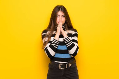 Genç kadın sarı duvarın üzerinden birlikte palm tutar. Kişi için bir şey sorar