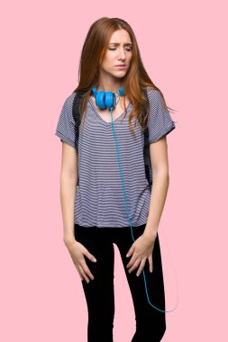 Kızıl saçlı öğrenci kadın izole pembe arka plan üzgün hissediyorum