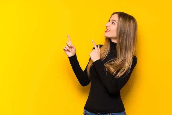 Jovem Mulher Bonita Sobre Fundo Amarelo Apontando Com Dedo Indicador — Fotografia de Stock