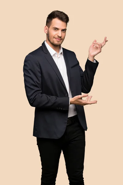 Handsome Business Man Extending Hands Side Inviting Come Ocher Background — Stock Photo, Image