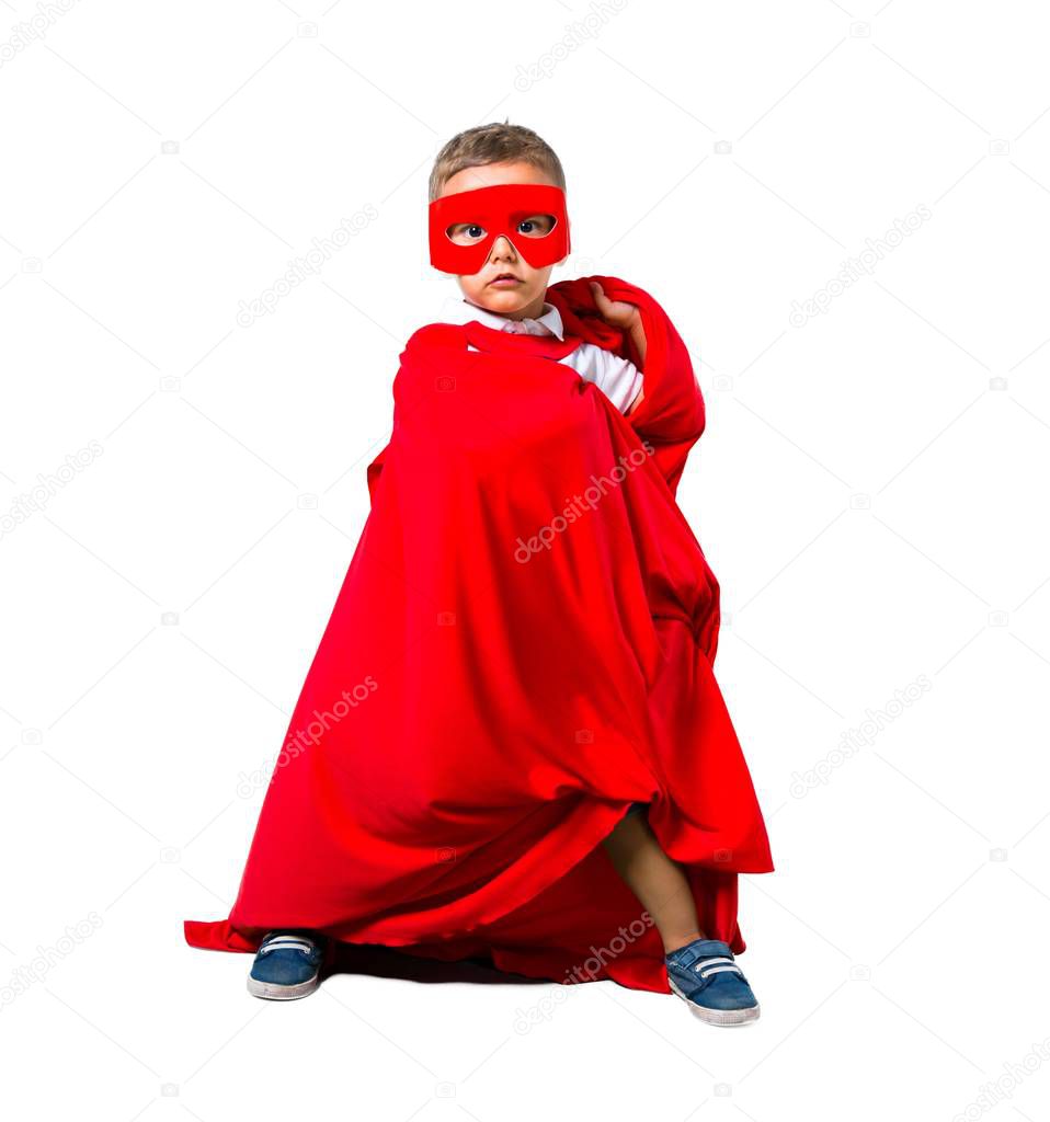 Little kid dressed like superhero on isolated white background