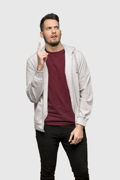 Man Sweatshirt Thinking Idea Pointing Finger Grey Background — Stock Photo, Image