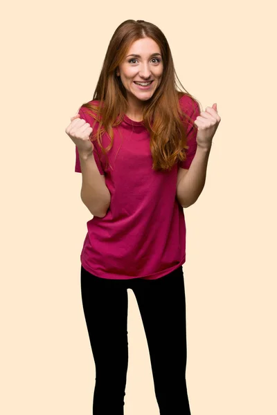Young Redhead Girl Celebrating Victory Winner Position Isolated Yellow Background — Stock Photo, Image