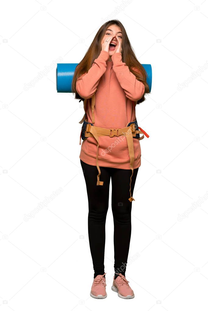 Full-length shot of Hiker girl shouting and announcing something on isolated white background