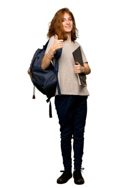 Çünkü iyi bir şey izole beyaz arka plan üzerinde oldu bir başparmak yukarıya hareket veren bir genç redhead öğrenci tam uzunlukta bir kadeh