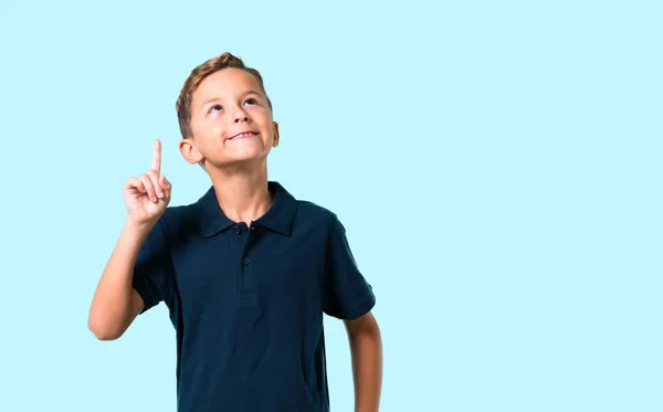 Little Boy Standing Thinking Idea Blue Background — Stock Photo, Image