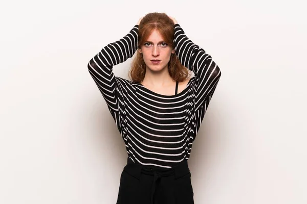 Young Redhead Woman White Wall Takes Hands Head Because Has — Stock Photo, Image