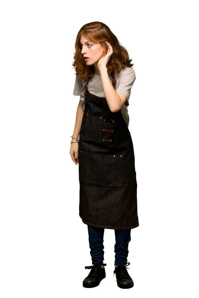 Full Length Shot Young Redhead Woman Apron Listening Something Putting — Stock Photo, Image