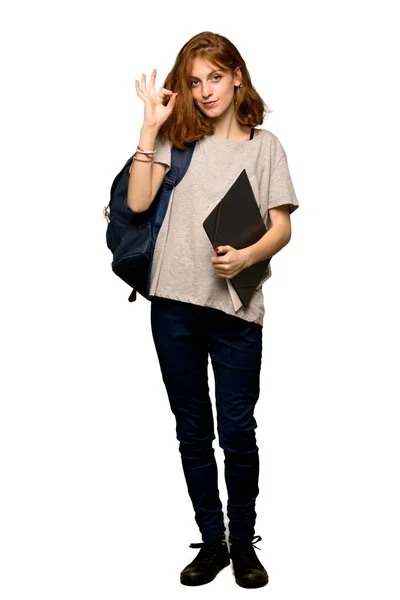 stock image A full-length shot of a Young redhead student showing an ok sign with fingers over isolated white background