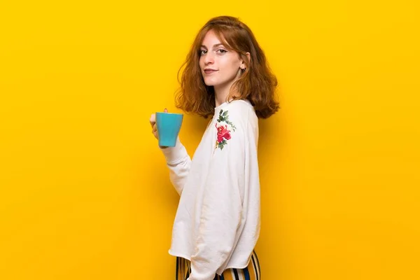 Young Redhead Woman Yellow Wall Holding Hot Cup Coffee — Stock Photo, Image
