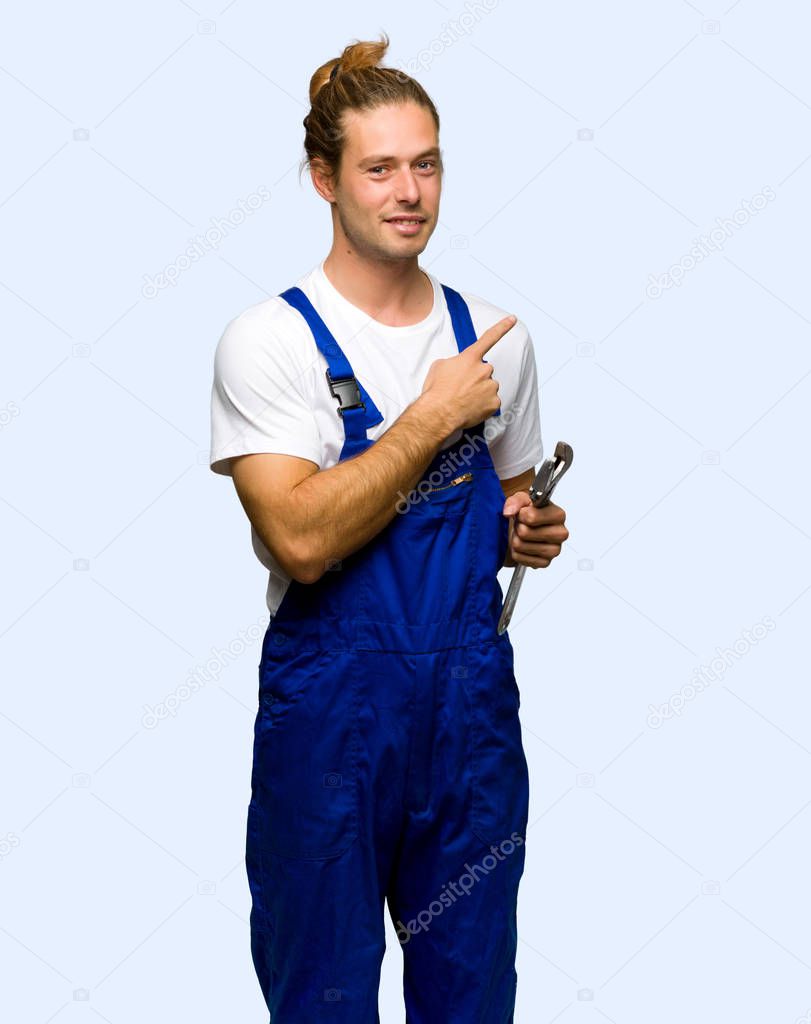 Workman pointing to the side to present a product on isolated background