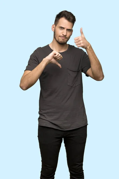 Man Black Shirt Making Good Bad Sign Undecided Yes Blue — Stock Photo, Image