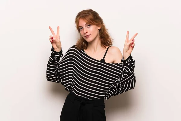 Young Redhead Woman White Wall Smiling Showing Victory Sign Both — Stock Photo, Image