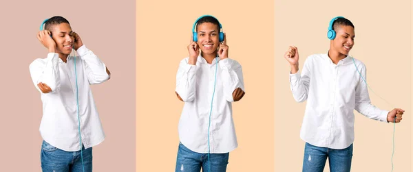 白いシャツがヘッドフォンで音楽を聴く若いアフリカ系アメリカ人のセット — ストック写真