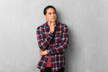 Adam grunge duvar üzerinde yukarı bakarken bir fikir düşünme