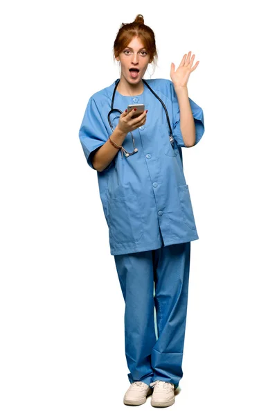 Full Length Shot Young Redhead Nurse Surprised While Sending Message — Stock Photo, Image