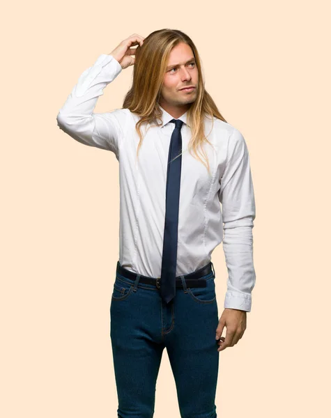 Blond Businessman Long Hair Having Doubts While Scratching Head Isolated — Stock Photo, Image