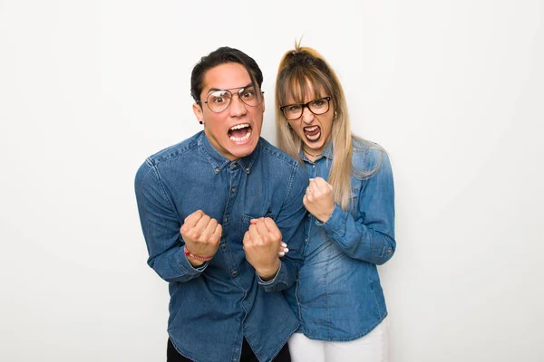 Young couple with glasses frustrated by a bad situation