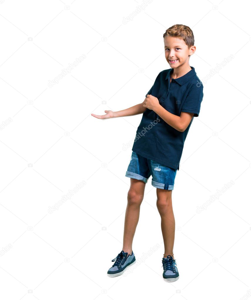 Full body of Little boy pointing back with the index finger on white background