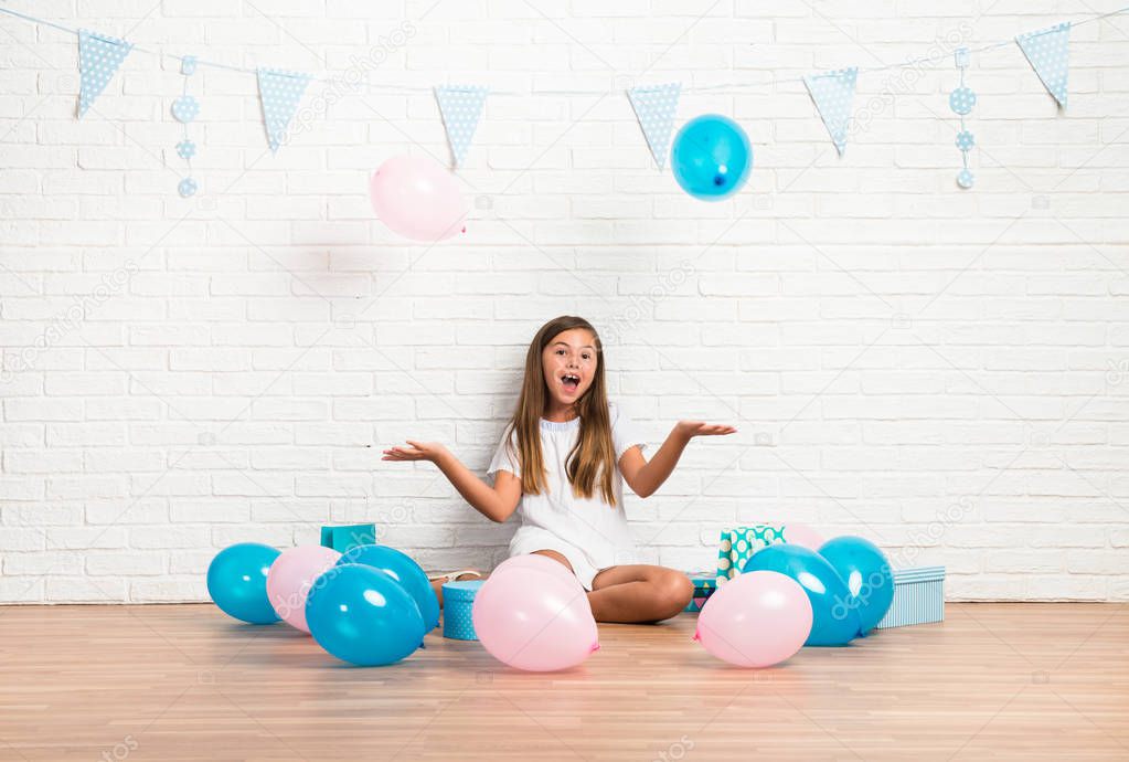 Little girl in a birthday party playing with balloons