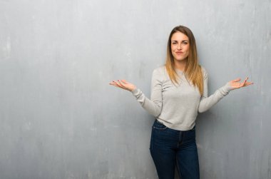 Genç kadın dokulu duvar mutsuz ve bir şey ile sinirli çünkü bir şey anlamıyor