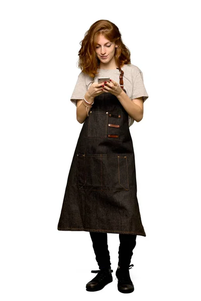 Full Length Shot Young Redhead Woman Apron Sending Message Mobile — Stock Photo, Image