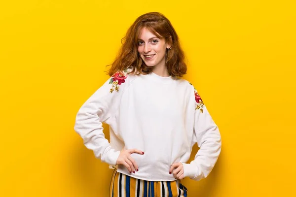 Young Redhead Woman Yellow Wall Posing Arms Hip Laughing — Stock Photo, Image