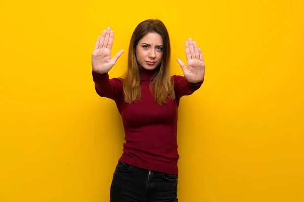 Vrouw Met Coltrui Gele Muur Maken Stop Gebaar Teleurgesteld — Stockfoto