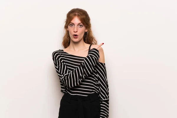 Young Redhead Woman White Wall Surprised Pointing Side — Stock Photo, Image