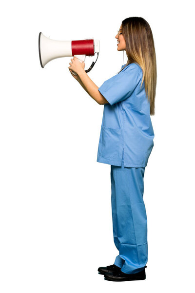 Full body of Young nurse shouting through a megaphone