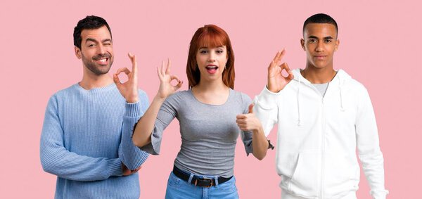 Group of three friends showing an ok sign with fingers