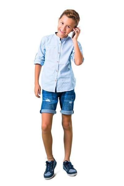 Little kid talking to mobile on isolated white background
