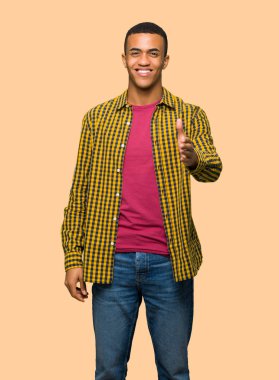 Genç afro Amerikalı adam izole arka plan üzerinde iyi bir anlaşma kapanış tokalaşırken