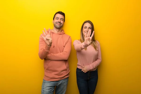 Група Двох Людей Жовтому Тлі Щаслива Рахує Чотири Пальцями — стокове фото
