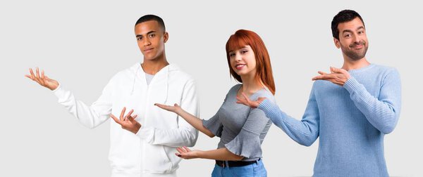 Group of three friends presenting and inviting to come