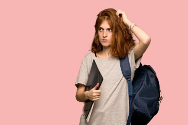 Pembe arka plan üzerinde kafa çizilmemesi süre şüpheleri genç redhead öğrenci