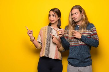 Hippi çift korkuttu ve tarafına işaret sarı arka plan üzerinde